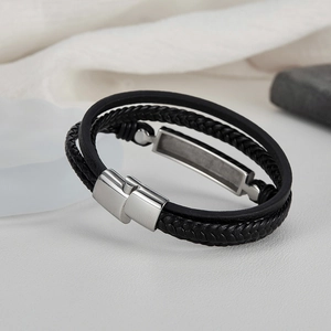 Close-up of black multilayer braided leather bracelet with silver magnetic metal clasp