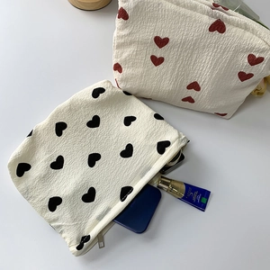 Macro detail of puffy heart pattern makeup bag with smooth zipper closure for storage