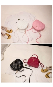 Flat lay of small semi-circle quilted crossbody bags in white, pink, black and burgundy