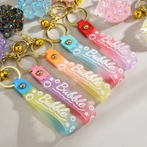 Detail of colorful gradient cat paw keychains with glitter and Bubble wristbands