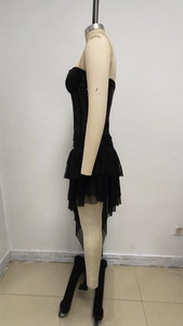 Detail of black strapless tube top with layered asymmetrical fishtail mesh skirt