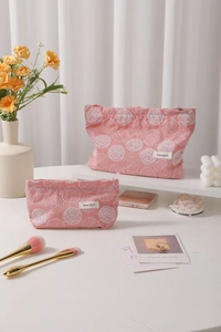 Detail of two-piece pink cotton cosmetic bags with fine white leaf embroidery and zipper