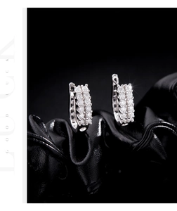 Detailed macro view of S925 silver U-shaped hoop earrings with double-row pavé crystals