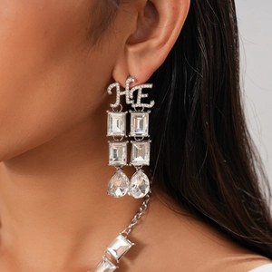 Detail of luxury geometric necklace and dangle earrings set with sparkling water drop crystals