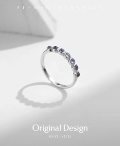 Close-up of S925 sterling silver moonstone ring with purple pavé set stones on white background