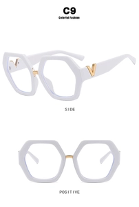 Detail view of white hexagonal glasses frame with gold V-shaped metal temple accents