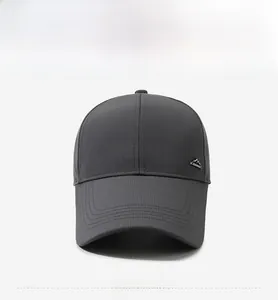 Close-up of dark grey baseball cap with quick-dry fabric and metal mountain badge