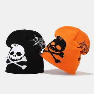 Detailed view of knitted Halloween beanies with skull and spider web jacquard patterns