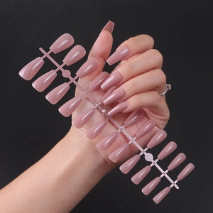 Glossy mauve long coffin press-on nails with shiny UV finish shown on a model hand