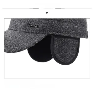 Detail view of winter flat cap showing warm ear flaps and thick grey tweed fabric texture