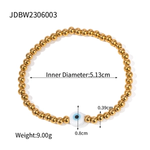 Gold stainless steel beaded bracelet featuring a central blue evil eye charm on white background