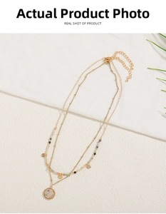 Detail of layered gold choker necklace with colorful beads and marble stone pendant