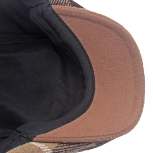 Macro shot of brown plaid wool blend beret showing durable stitching and inner sweatband