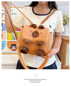 Detailed view of plush Capybara bag showing soft texture and crossbody strap on model