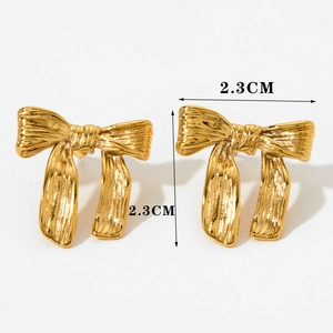 Detail of gold bow earrings measuring 2.3cm by 2.3cm with polished texture