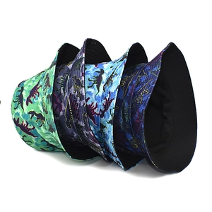 Detail showing four colors of dinosaur print bucket hats with breathable cotton fabric