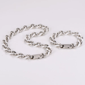 Detail of silver chain jewelry set with white ceramic links and secure metal clasp
