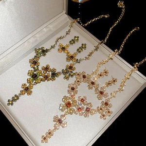 Vintage floral jewelry set with necklaces and earrings in green and champagne tones