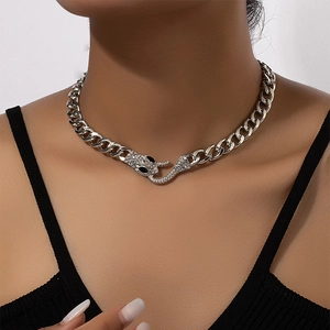 Silver snake head Cuban link necklace with sparkling rhinestones on female model