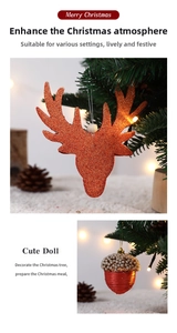 Detail of glitter reindeer and pearl acorn ornaments hanging on a Christmas tree