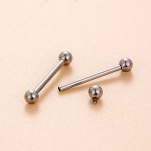 Internal thread G23 titanium barbell tongue ring with screw design and ball top on beige texture