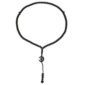 Detail of 99 black prayer beads with crescent star pendant and tassel on white background
