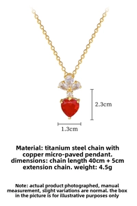 Detailed view of luxury heart pendant with red gem and dimensions 2.3cm by 1.3cm