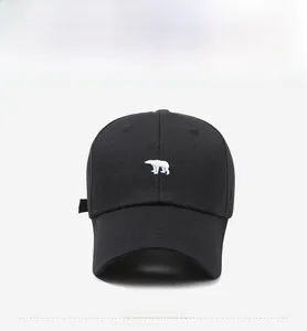 Front view detail of a black cotton baseball cap with white polar bear embroidery