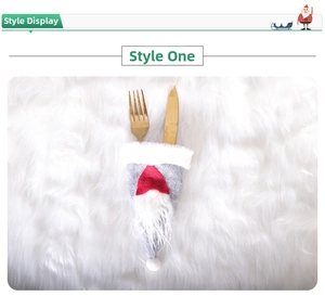 Close-up of a grey gnome felt cutlery holder with a red hat for Christmas table decor
