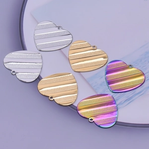 Detailed view of heart-shaped stainless steel charms in gold, silver and rainbow finish