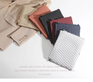 Detail of multi-color woven leather clutch bags with premium texture and metal zipper