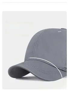 Detail of grey short brim baseball cap showing the wide visor and premium cotton stitching