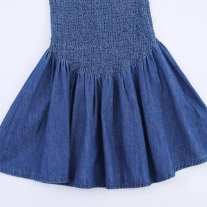 Dark blue denim mini dress with smocked elastic texture and flared honeycomb hemline