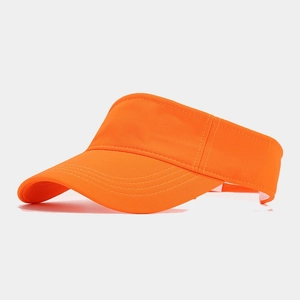 Detail view of bright orange sun visor hat with precise stitching and breathable fabric