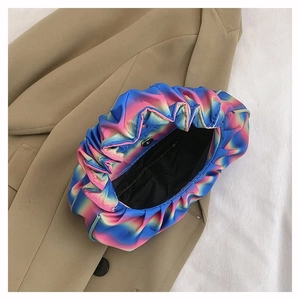 Top view of pleated rainbow dumpling bag on beige trench coat showing satin texture