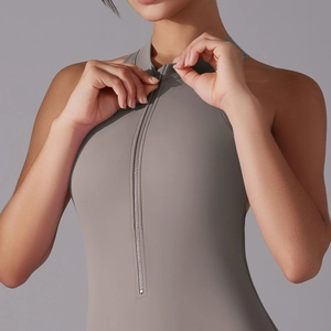 Detailed view of the front metal zipper on a taupe high-stretch athletic bodysuit