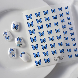 Macro view of blue butterfly 5D embossed nail art stickers with intricate 3D texture