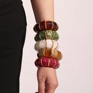 Fashionable resin stretch bracelet set in amber, emerald, and marble colors with gold bars