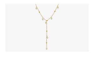 Detail of Y-shaped gold-plated necklace featuring baroque pearls on white background
