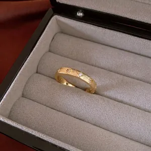 Star-patterned gold brushed open ring with zircons in a luxury jewelry box display