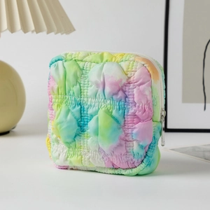 Macro shot of colorful quilted seersucker cosmetic bag showing texture and stitching detail