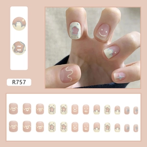 Short round press-on nails with yellow smiles and blue stars in matte pastel colors