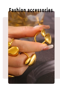 Close-up of golden irregular bean-shaped double ball ring with high polished finish