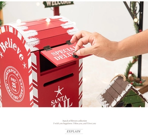 Close-up of red wooden Santa Mail mailbox with North Pole Express stamp and hand opening lid
