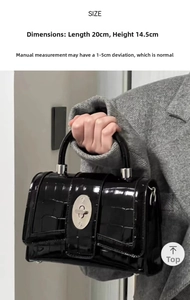 Detail view of black crocodile pattern patent leather bag with size 20cm x 14.5cm