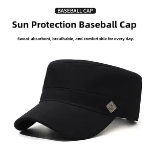 Detail of the black cotton flat top cap showing texture and silver metal plaque logo