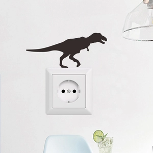Detail view of a black dinosaur silhouette wall sticker placed above a white light switch