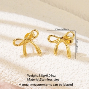 Macro shot of gold bow stud earrings in stainless steel with precise size dimensions