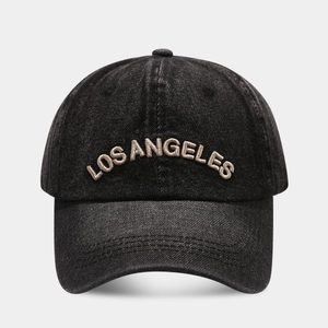 Detail of Los Angeles embroidery on vintage black denim baseball cap fabric
