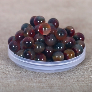 Macro shot of dark red and blue gradient beads with holes for DIY jewelry making